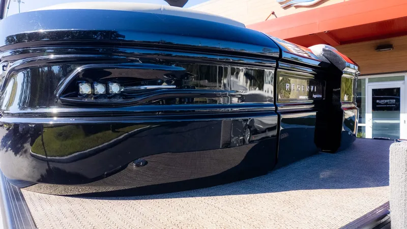 Slide: The Image of Close-up of the shiny black hull of a 2024 Barletta Reserve Leggera 26MA. - 3