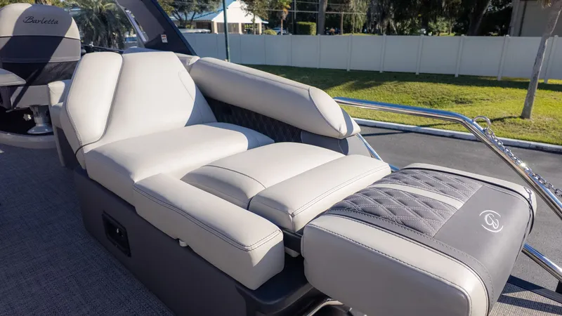Slide: The Image of The image shows a luxurious lounging area on a boat, surrounded by well-kept grass. - 9