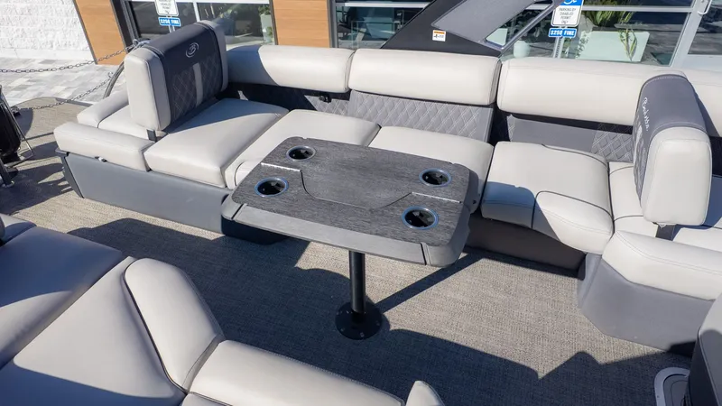 Slide: The Image of Interior of a 2024 Barletta Reserve Leggera 26MA with gray seating and a table. - 12