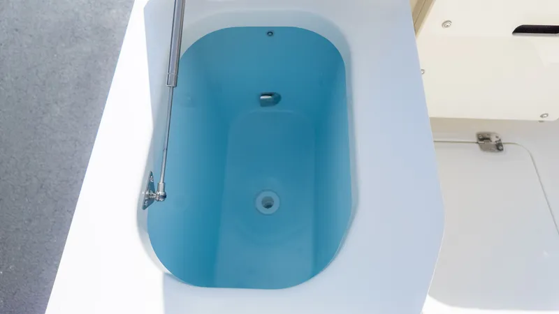 Slide: The Image of An oval, blue basin on a boat, possibly a livewell. - 16