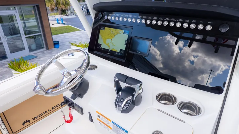 Slide: The Image of The image shows the cockpit of a World Cat 265CC boat with a modern helm and navigation system. - 22