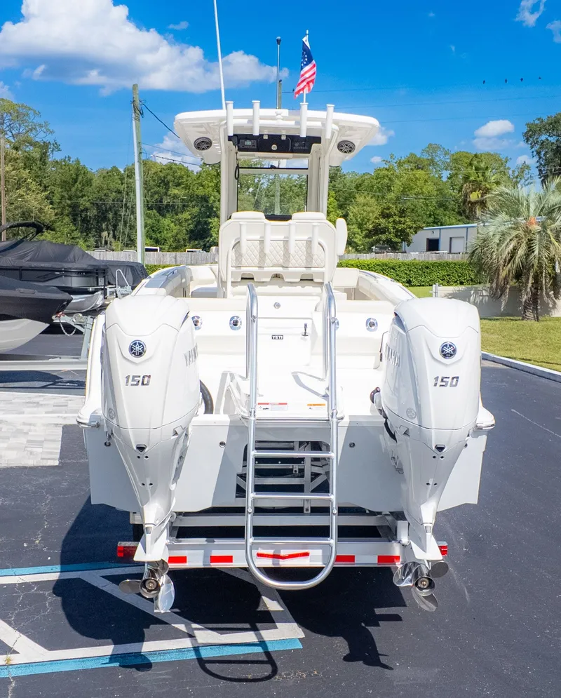 Slide: The Image of A World Cat 265CC boat with twin Yamaha 150 engines, parked on a lot. - 3