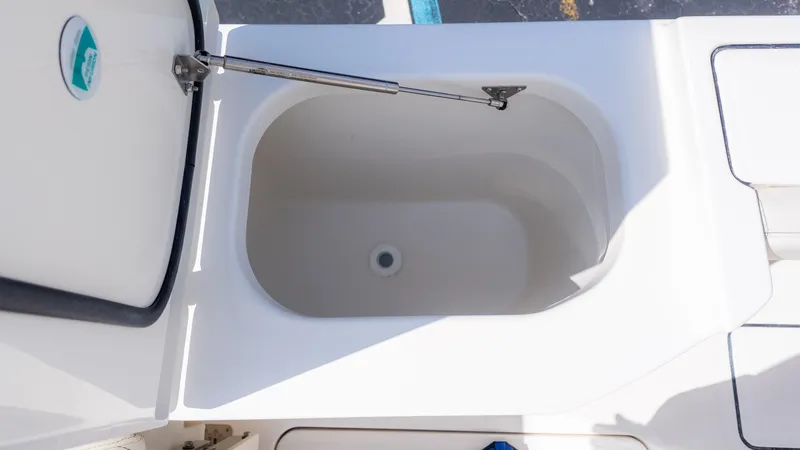 Slide: The Image of An open storage compartment on a 2026 World Cat 265CC boat. - 18