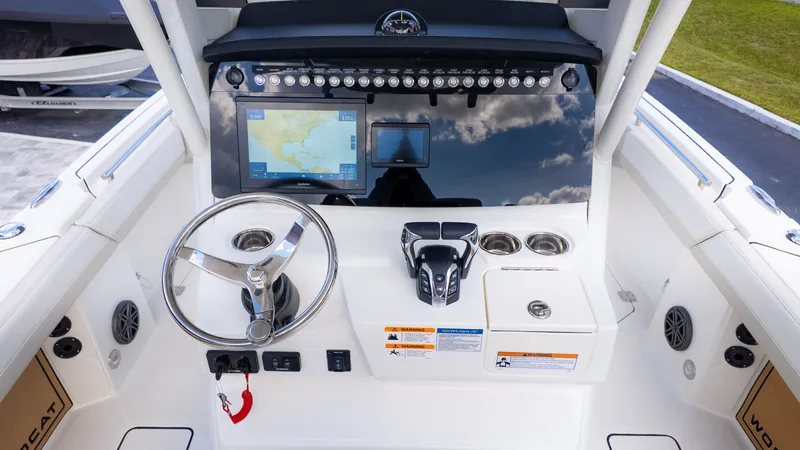 Slide: The Image of The cockpit of a 2026 World Cat 265CC with steering wheel, screens, and controls. - 21