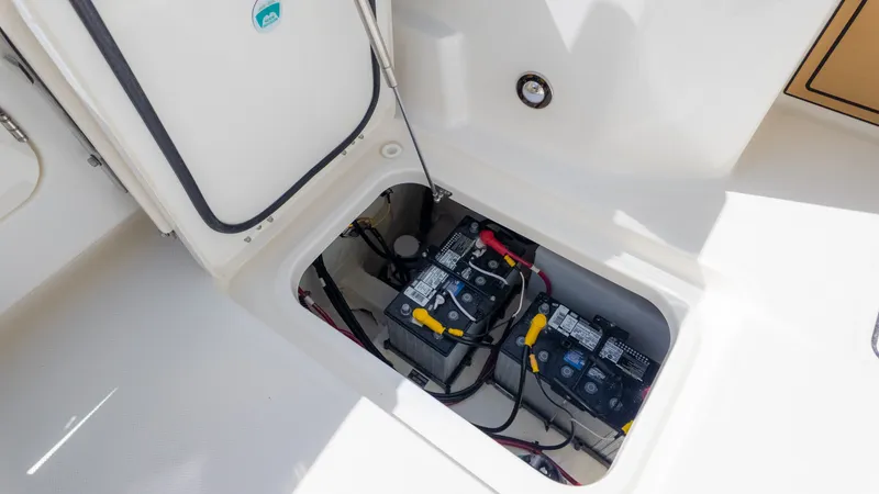 Slide: The Image of Battery compartment of a World Cat 265CC boat with two batteries and cables. - 17