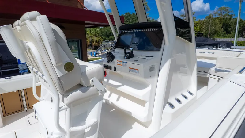 Slide: The Image of The image shows the cockpit of a World Cat 265CC boat with white seats and a helm console. - 11