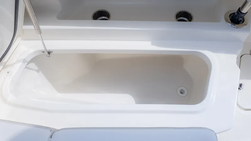 Slide: The Image of Close-up of a white boat cooler or storage compartment with a drain. - 23