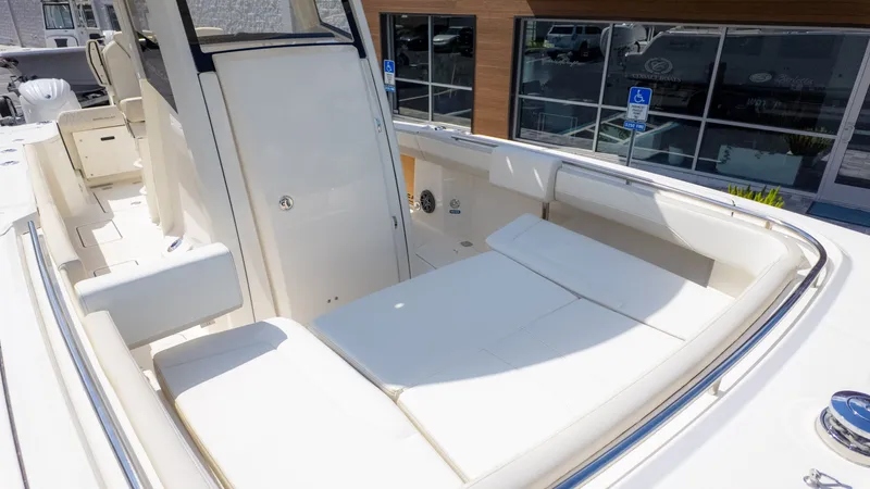 Slide: The Image of The image shows the deck of a World Cat 265CC boat with white cushions. - 12