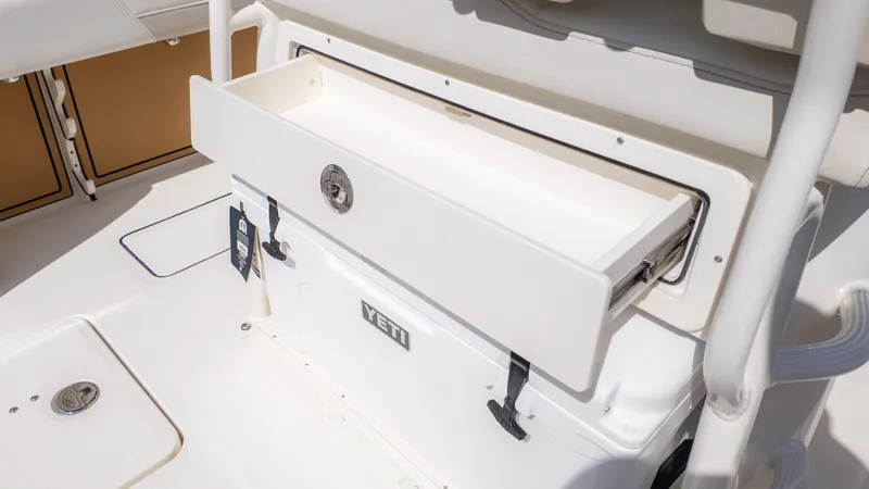 Slide: The Image of An open storage compartment with a Yeti cooler beneath it on a boat. - 7