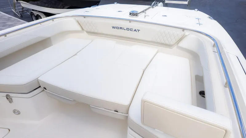 Slide: The Image of The image shows the spacious bow area of a World Cat 265CC with comfortable white cushions. - 22