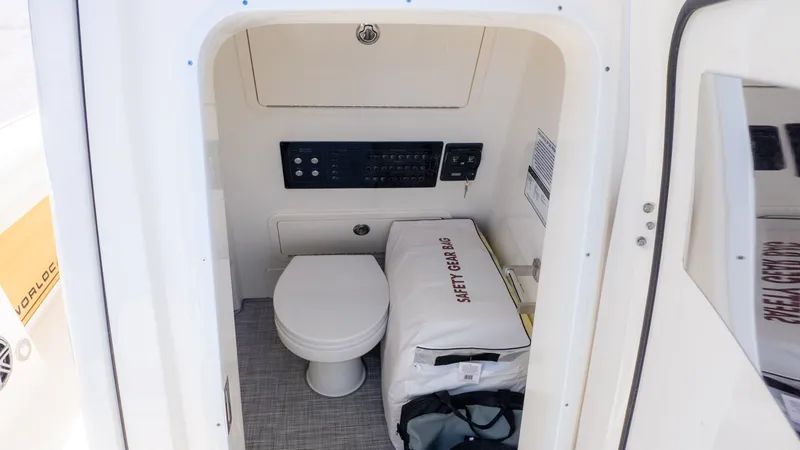 Slide: The Image of Interior of a boat cabin with a toilet, control panel, and safety gear. - 27
