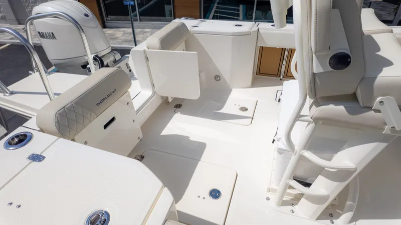Slide: The Image of The image shows the cockpit of a World Cat 265CC boat with beige seating and a Yamaha engine. - 3
