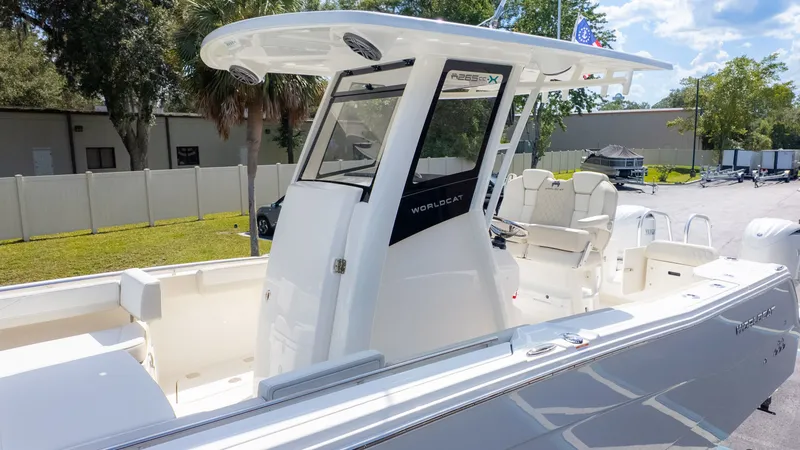 Slide: The Image of A modern catamaran with a center console, spacious deck, and sleek white finish. - 14
