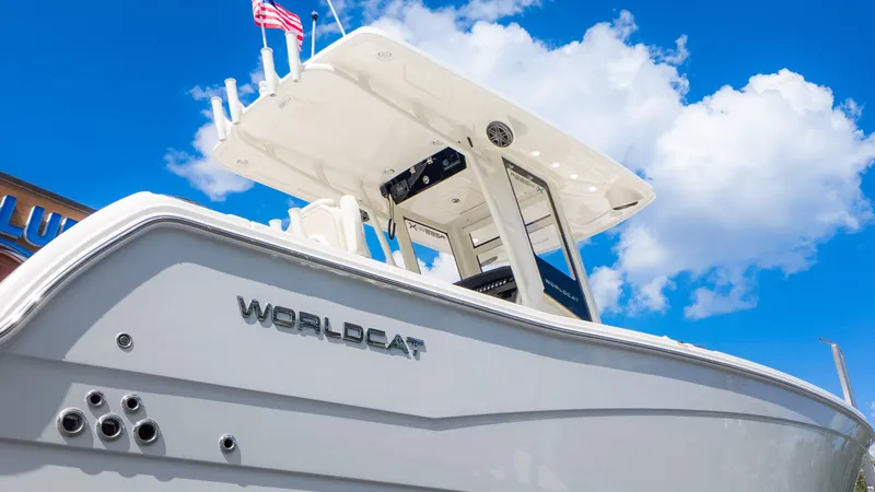 Slide: The Image of A modern World Cat 265CC boat with sleek white design under a clear blue sky. - 29