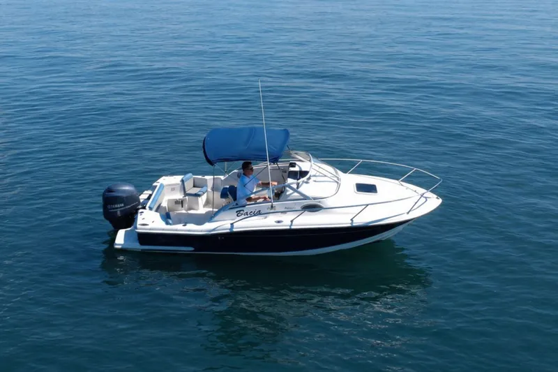 Slide: The Image of 2008 Scout 222 Abaco boat with blue canopy cruising on calm water. - 4