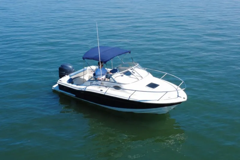 Slide: The Image of 2008 Scout 222 Abaco boat with blue canopy on calm water. - 3