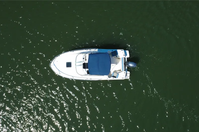 Slide: The Image of Aerial view of 2008 Scout 222 Abaco boat on green water. - 8
