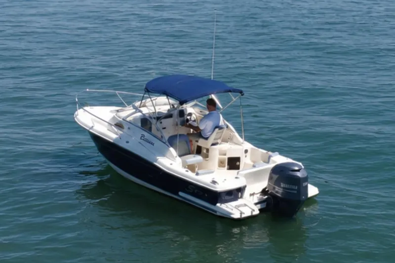 Slide: The Image of 2008 Scout 222 Abaco boat with blue canopy cruising on open water. - 5
