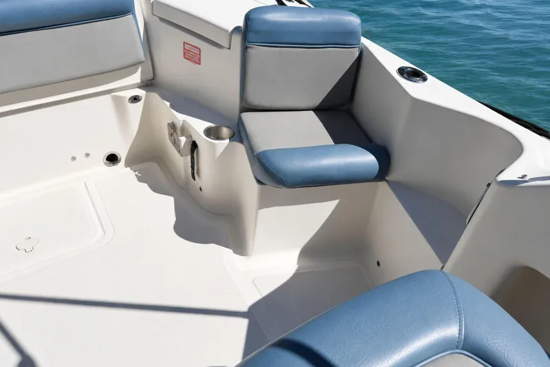 Slide: The Image of 2008 Scout 222 Abaco boat interior with blue and gray seating, cup holder, and ocean view. - 12