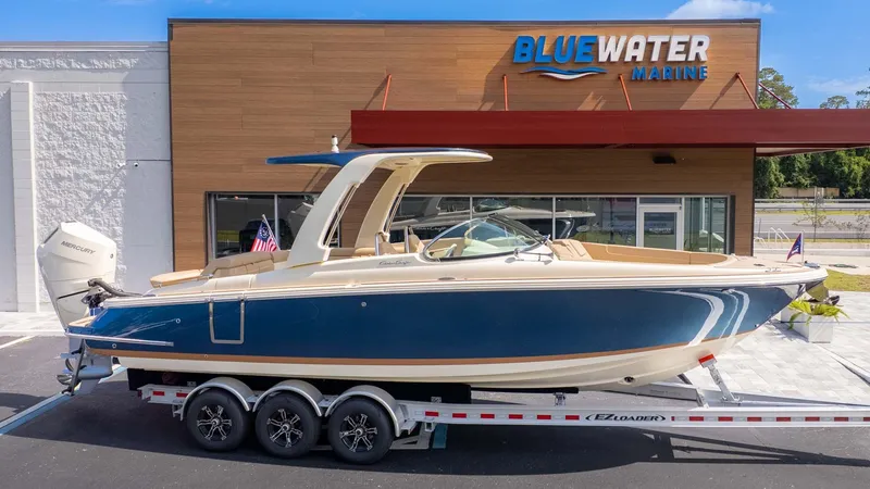 Slide: The Image of 2025 Chris-Craft Launch 28 GT on a trailer in front of a building. - 33