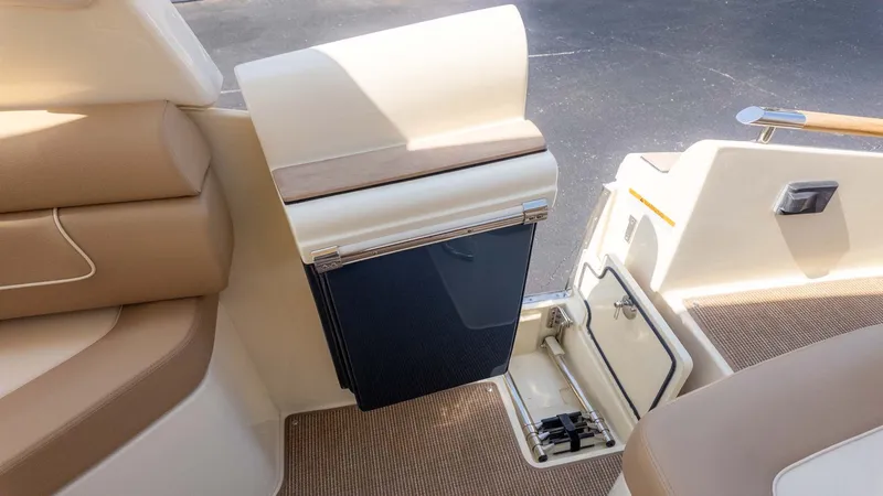 Slide: The Image of Interior of a Chris-Craft Launch 28 GT with sleek seating and a small refrigerator. - 9