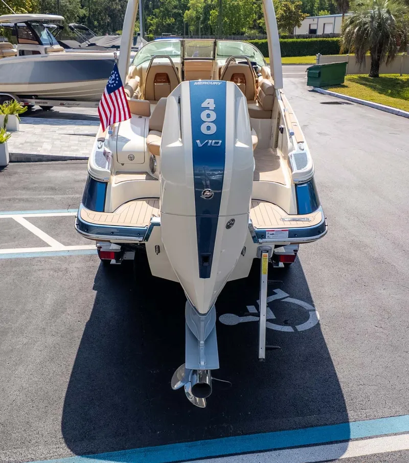 Slide: The Image of Rear view of a Chris-Craft Launch 28 GT with outboard motor and American flag. - 3
