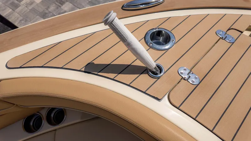 Slide: The Image of Close-up of a Chris-Craft Launch 28 GT boat deck with wood paneling and metal fittings. - 25