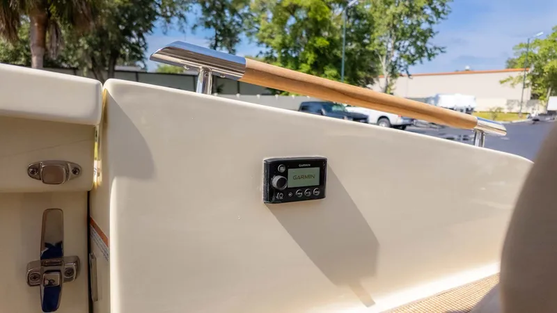 Slide: The Image of Close-up of a boat deck with Garmin device and wooden railing. - 13