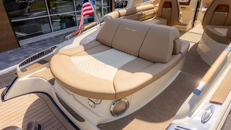 Slide: The Image of Luxurious sun deck on a Chris-Craft Launch 28 GT, featuring comfortable cushions and an American flag. - 6