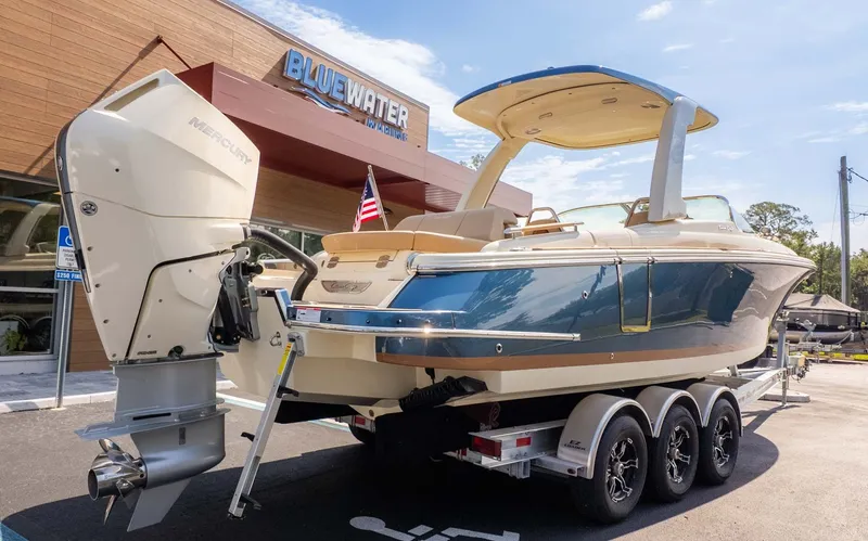 Slide: The Image of 2025 Chris-Craft Launch 28 GT on a trailer outside a building. - 3