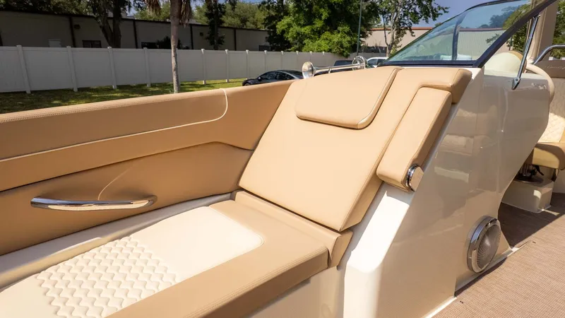 Slide: The Image of The image shows the luxurious cockpit of a Chris-Craft Launch 28 GT with beige upholstery. - 25