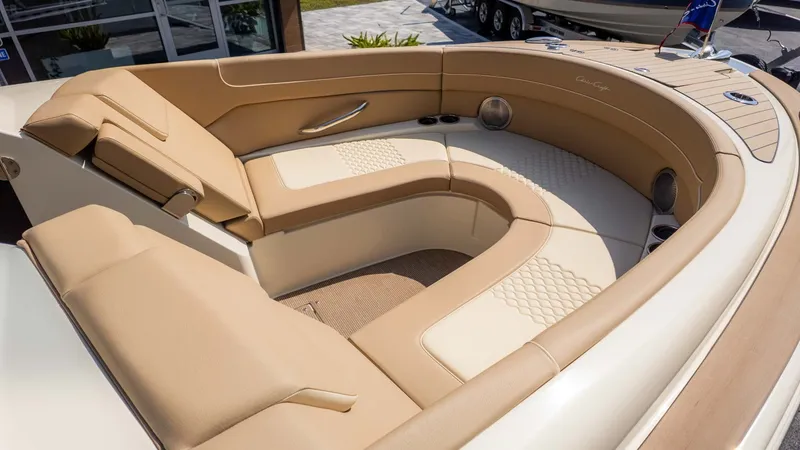 Slide: The Image of The image shows the luxurious cockpit of a Chris-Craft Launch 28 GT with beige upholstery. - 10