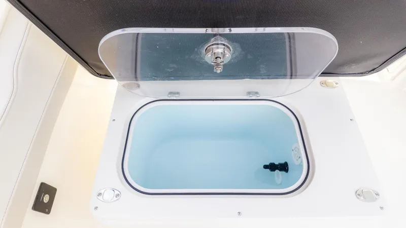 Slide: The Image of An open compartment with a transparent lid on a boat. - 21