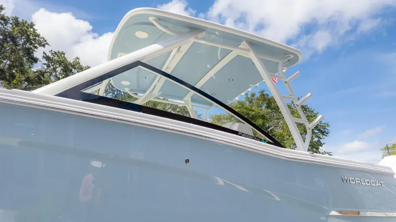 Slide: The Image of A modern boat with a blue hull and white roof, surrounded by trees and blue sky. - 7