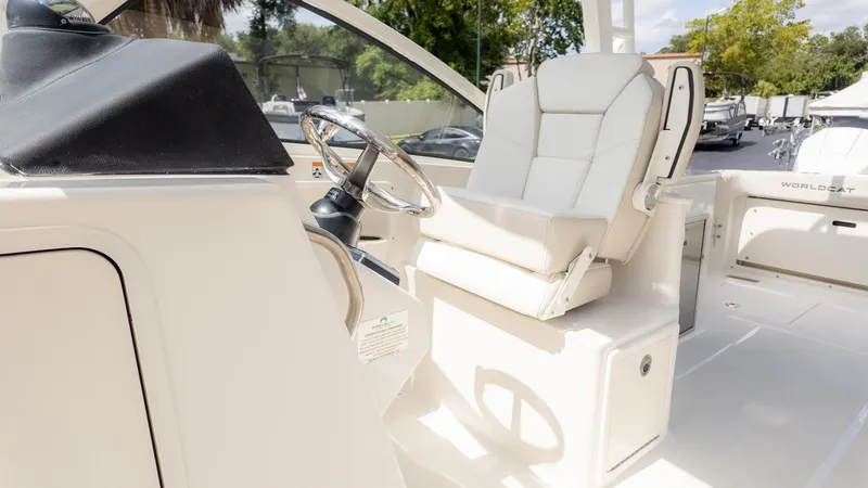 Slide: The Image of The image shows the cockpit of a World Cat 280 Dual Console boat with a white seat. - 36