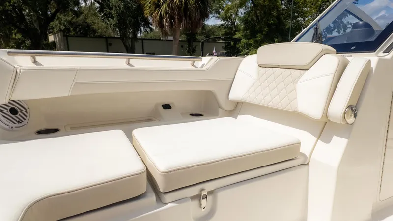 Slide: The Image of The 2026 World Cat 280 Dual Console features luxurious cream-colored upholstery in the seating area. - 34
