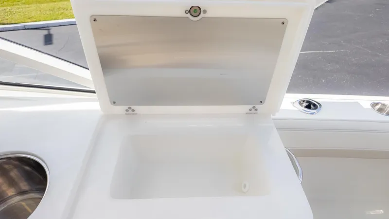 Slide: The Image of An open storage compartment on a boat with a white interior and stainless steel details. - 18