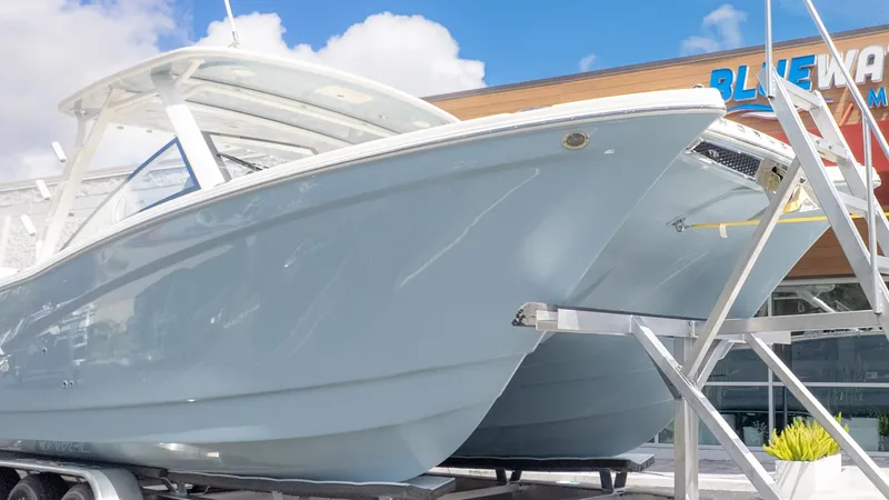 Slide: The Image of A modern dual-hull boat on a trailer in front of a building. - 3