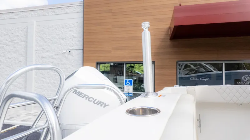 Slide: The Image of A World Cat 280 Dual Console boat with Mercury engine, parked in front of a building. - 12