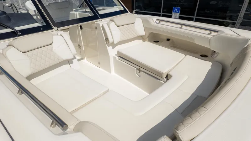 Slide: The Image of Interior view of a luxurious boat with cream-colored upholstery and sleek details. - 28