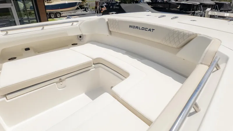 Slide: The Image of The image shows the spacious cockpit of a World Cat 280 Dual Console boat with beige upholstery. - 27