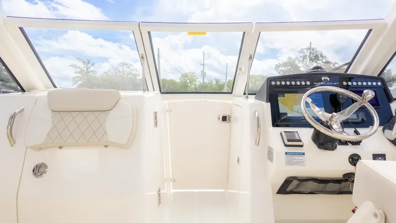Slide: The Image of Interior view of a modern boat with white seating and a steering console. - 24