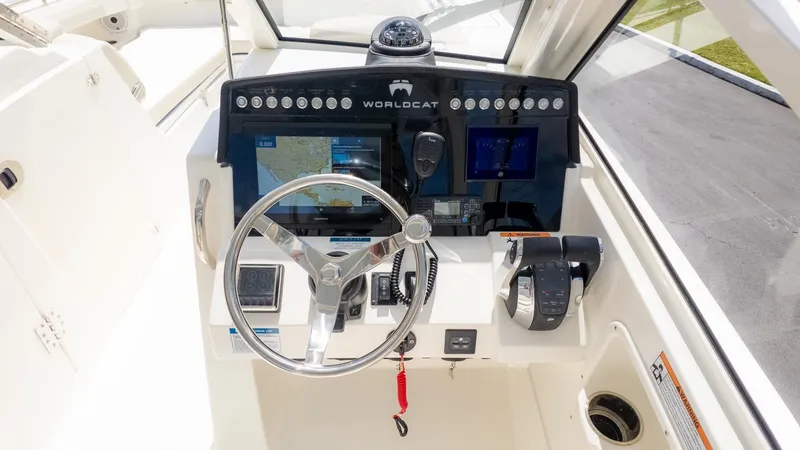 Slide: The Image of The image shows the helm of a World Cat 280 Dual Console boat with modern navigation equipment. - 36