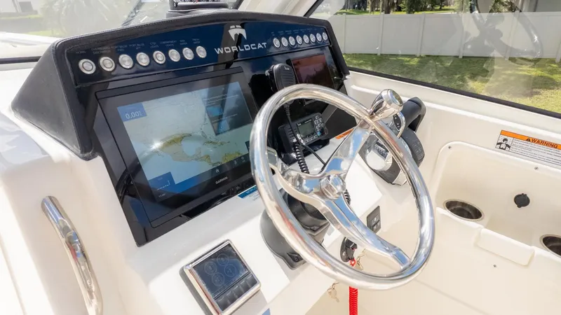 Slide: The Image of The image shows the helm of a World Cat 280 Dual Console boat with modern navigation systems. - 37