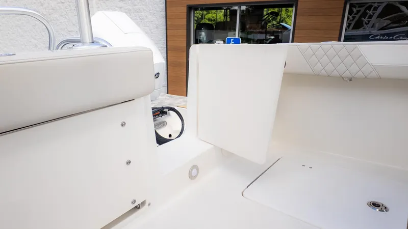 Slide: The Image of Interior view of a boat with white upholstery and storage space. - 12