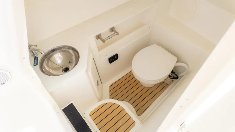 Slide: The Image of Interior view of a boat cabin with a toilet and sink. - 23