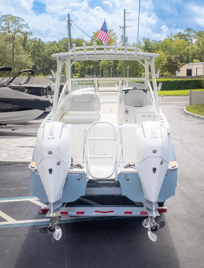 Slide: The Image of A 2026 World Cat 280 Dual Console boat with twin outboard engines, on a trailer. - 3