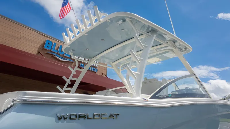 Slide: The Image of A World Cat 280 Dual Console boat with a sturdy roof and an American flag. - 40