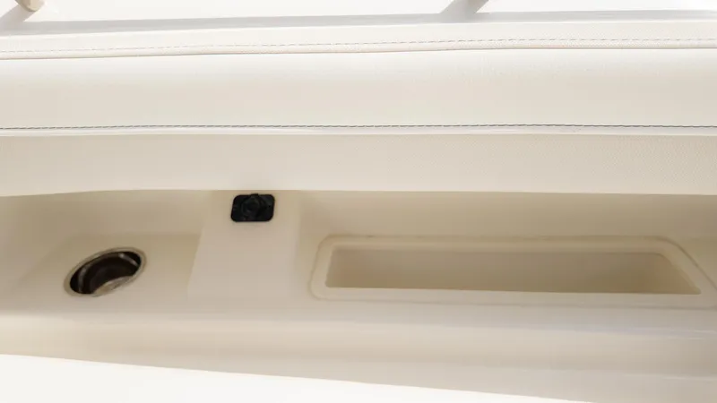 Slide: The Image of Close-up of a boat interior with a cup holder and storage compartment. - 30