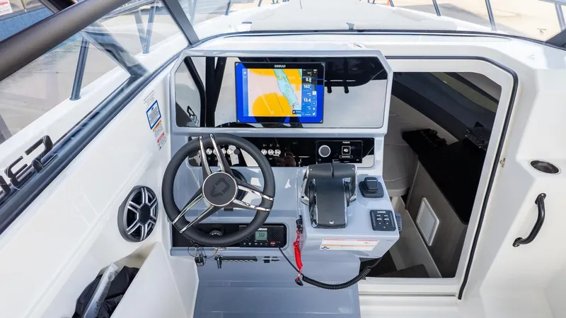 Slide: The Image of The image shows the helm of a modern boat with a large navigation screen. - 29